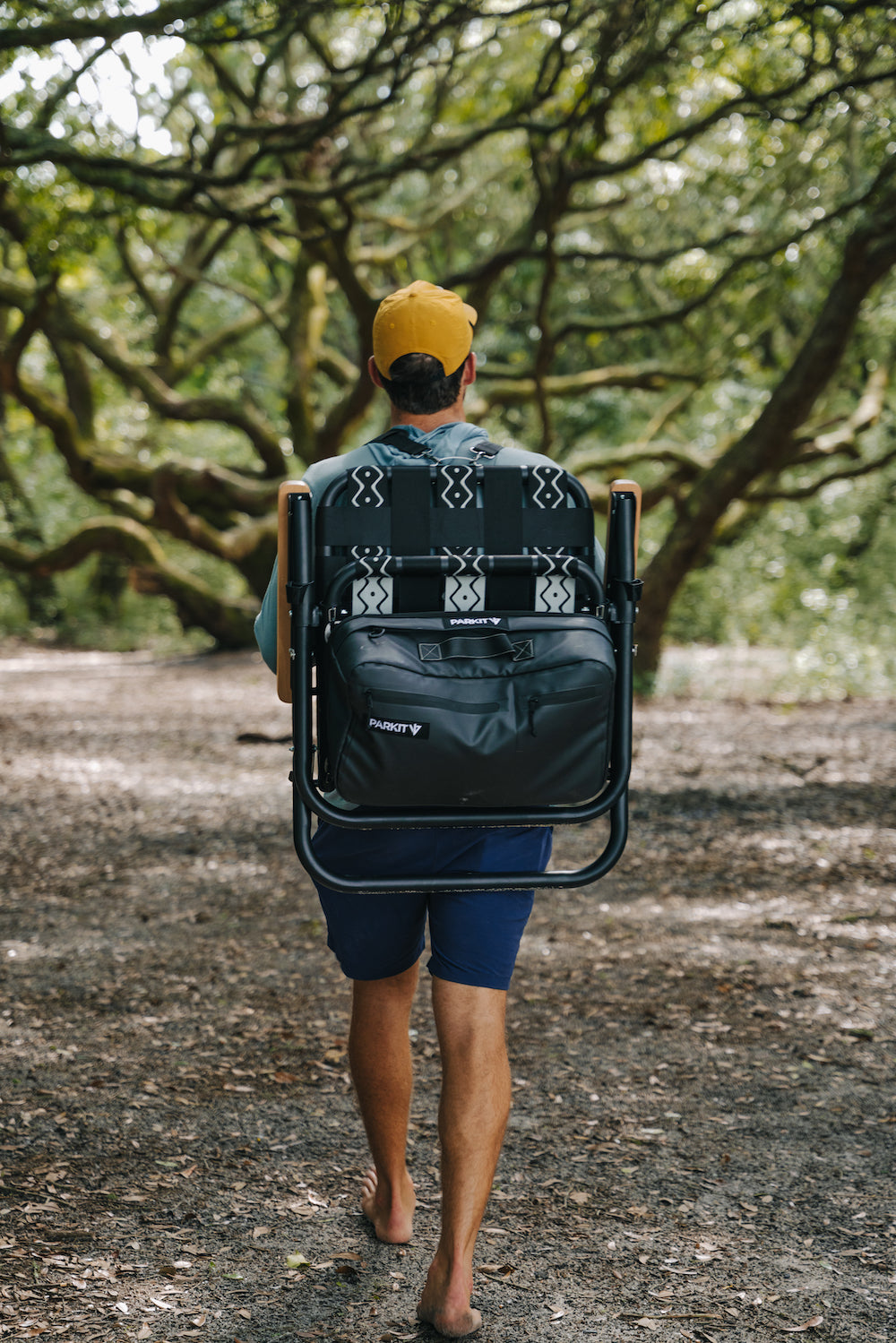 Man Carrying Voyager outdoor chair on a hike