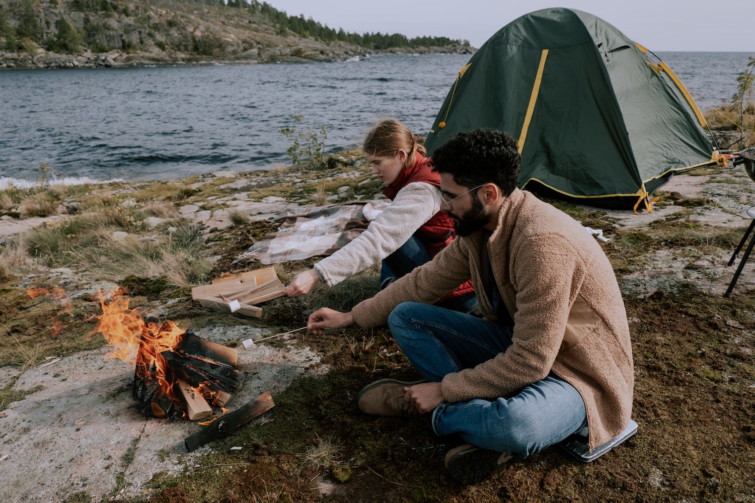 Man and woman following tent winter camping tips and tricks