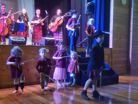 The Millmerran Music for All Bush Dance - Young kids playing violin on stage for the first time