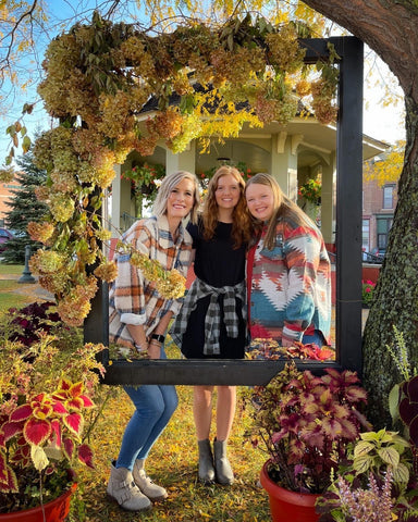 Anna, Jenna, and Naomi taking a picture at the Apple Affair photo spot