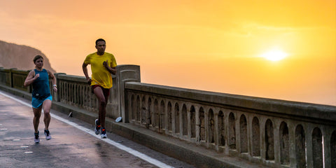 Two people running on the road