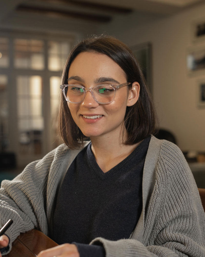 Young woman wearing LUMES Palmer Crystal blue light glasses