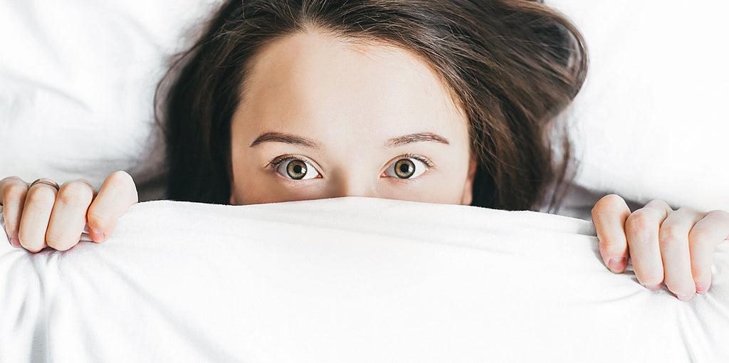Woman in bed with eyes wide open
