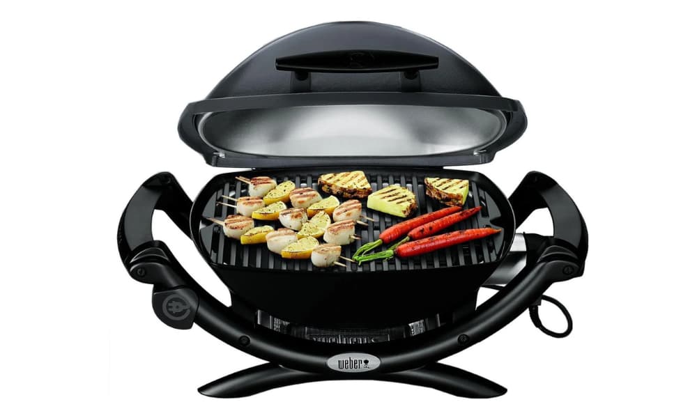 Seafood, fruits, and vegetables cooking on a Weber Q 1400 Electric Grill.