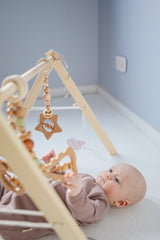 baby playing with baby gym