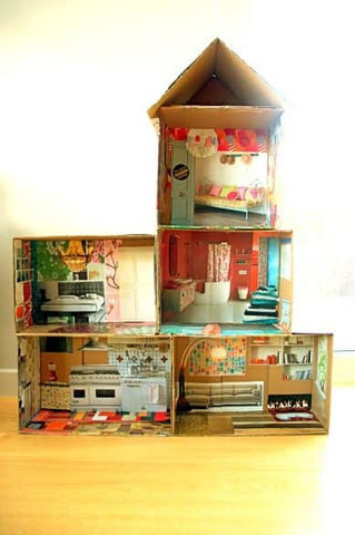 Cardboard dolls house using recycled magazine pages