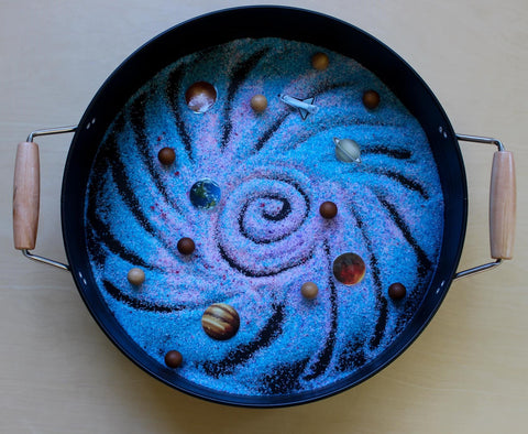 salt sensory play tray with a space and galaxy theme for world space week