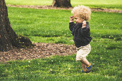 one year old running in a park