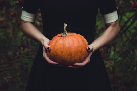 woman holding pumpkin for halloween