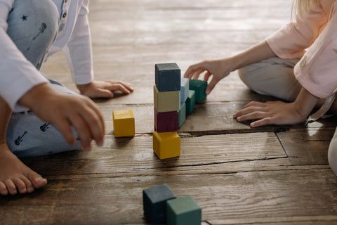 Stage 2 of Block Play two children stacking blocks as towers