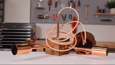 Wooden and copper light fixture with pink electrical cord