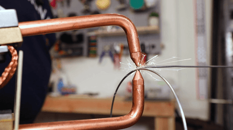 A man doing the welding to create a sturdy frame