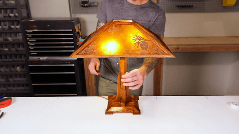 Person holding vintage-looking table lamp