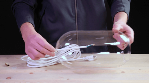 threading a cord into a glass shade
