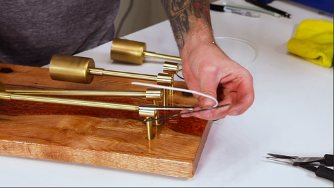 A man creating a wall sconce
