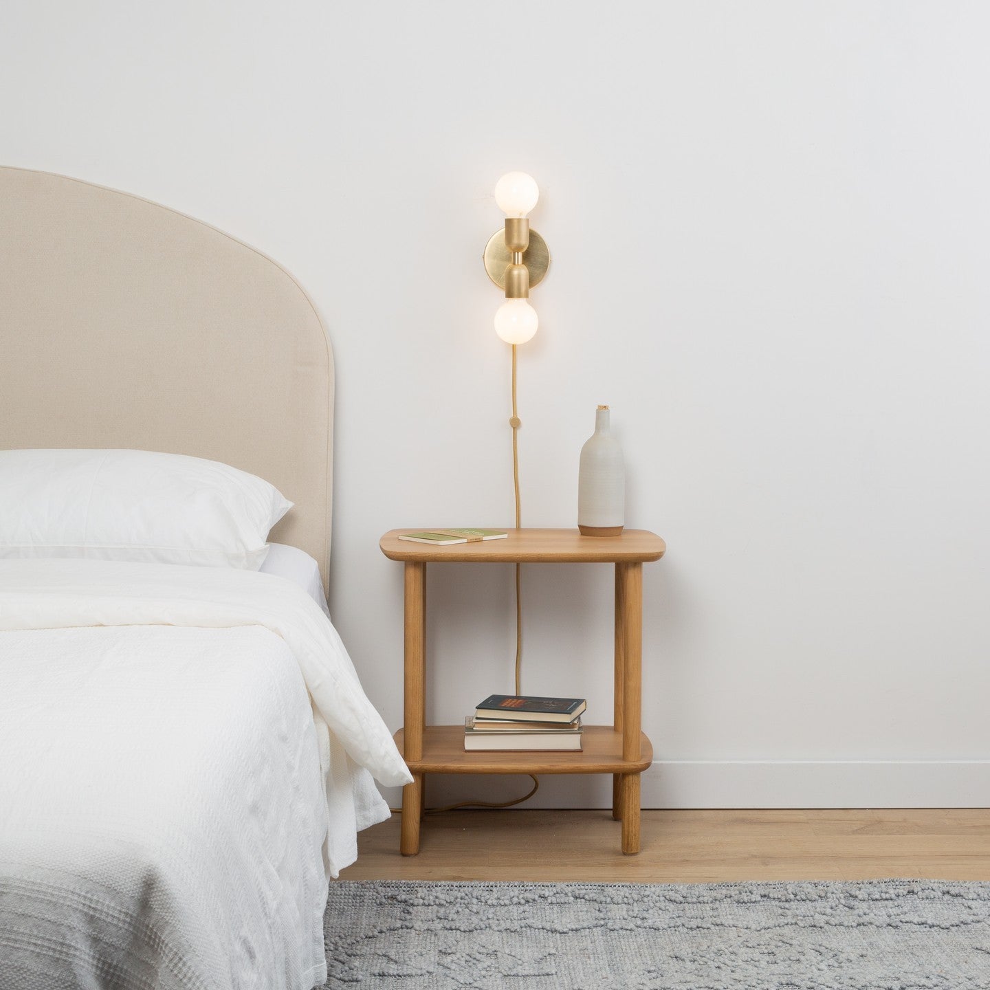 brass cord stay for wall sconce above nightstand