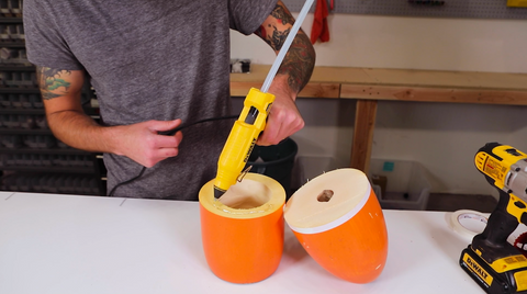 Person putting hot glue on bottom half of custom pendant light