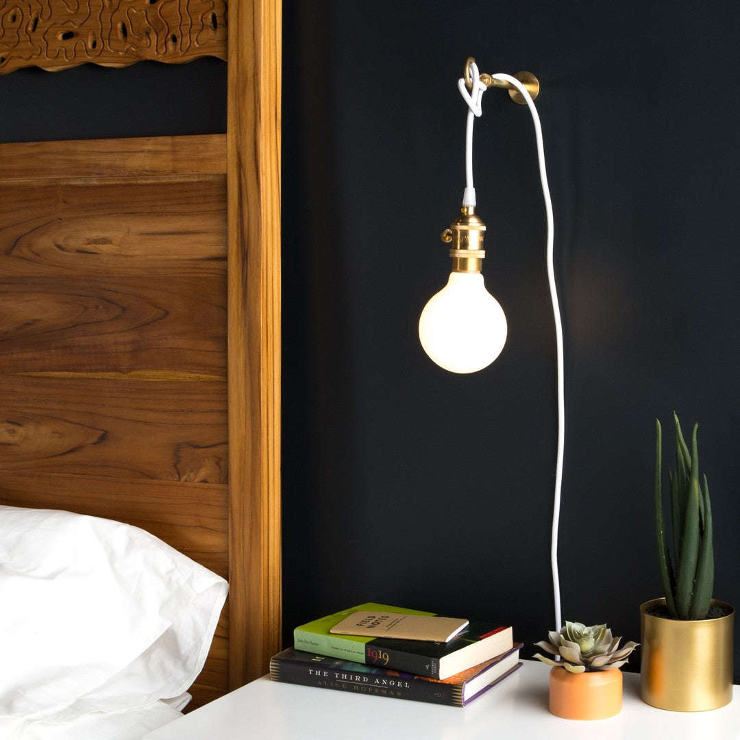 Simple bedside plug-in lamp with white cloth covered cord by Color Cord Company