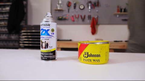 Aerosol can and can of wax sitting on workbench