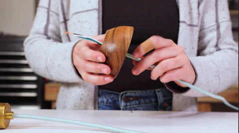 threading a wood bowl onto a light cord
