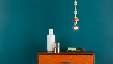 wood bead pendant light hanging over a shelf