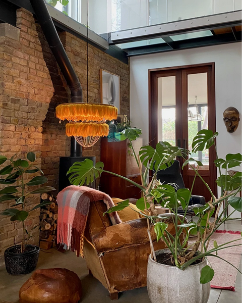 Yellow feather luxury chandelier in living room with plants