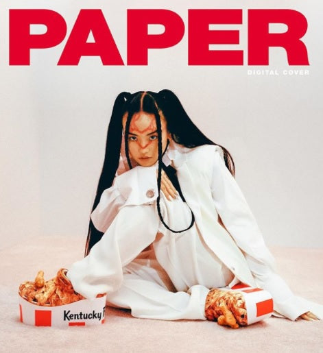 Paper magazine cover with Crocs X KFC collab shoes worn by model.