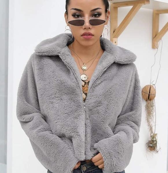 Model wearing a gray fur jacket.