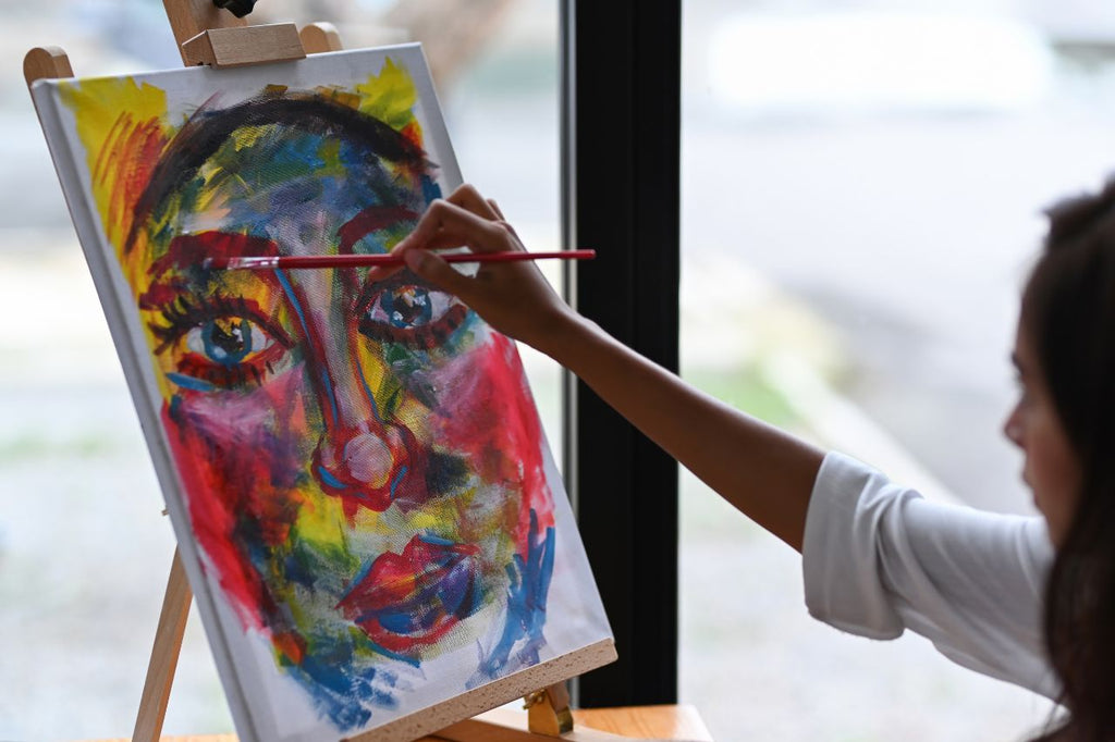 Woman creating a colorful Cannabis sativa inspired portrait.