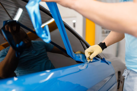 Man painting car blue with Ceramic Tint, Window Tint, Motorsport