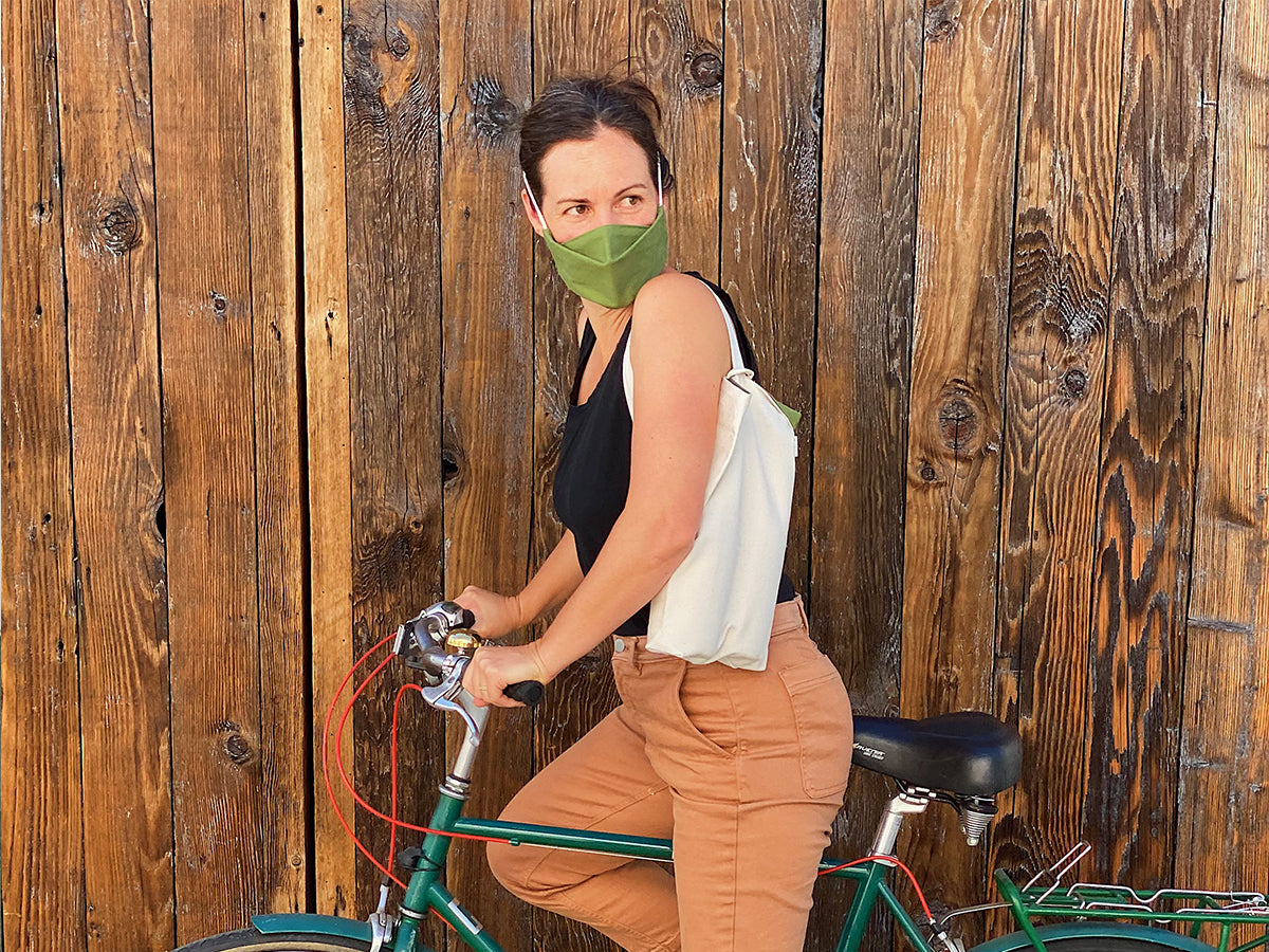 Martha Stoumen biking with wine in an Aplat two bottle wine tote