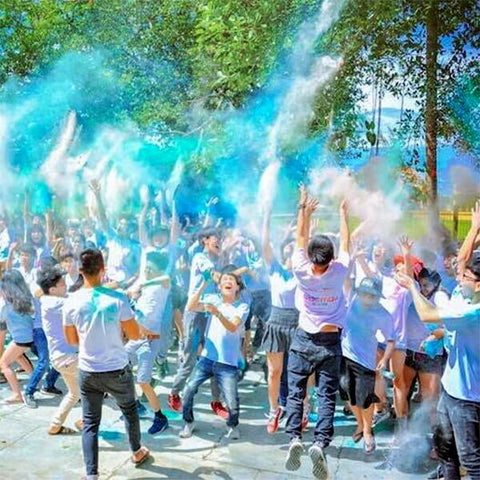 Group wears white clothes during Holi color celebration