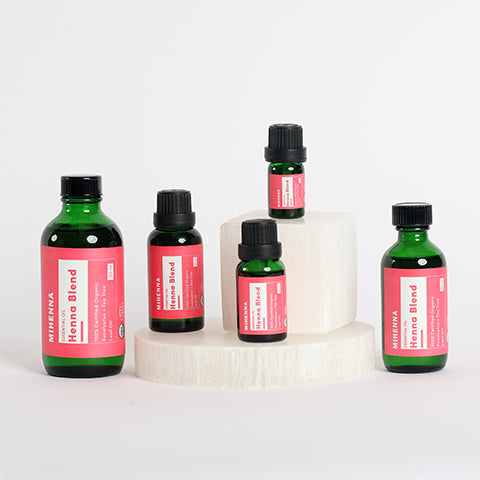 An image displaying five bottles of Mihenna’s henna essentials blend in bottles of different quantities.