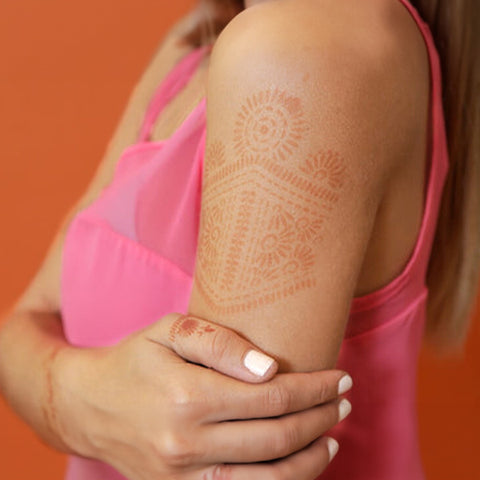 Woman with Aphrodite henna tattoo on her shoulder