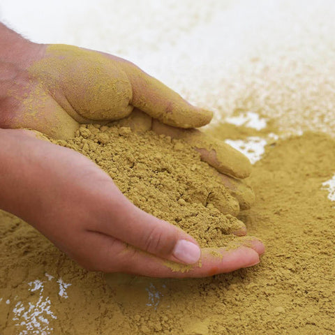 Hands holding organic henna powder