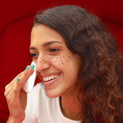 Wiping off henna freckles with cotton pad