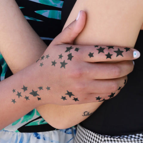 Star Tattoos on Person's Hand and Arm.