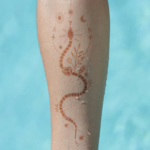 An image of a woman showing Sabrina henna design on her arm.