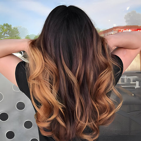 Woman with long, wavy hair in the caramel balayage style
