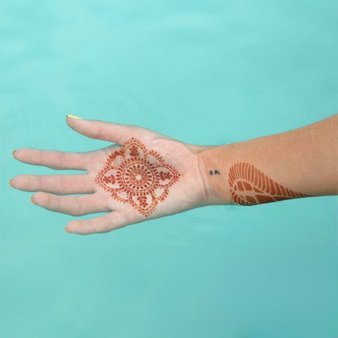Mandala henna tattoo on palm in water