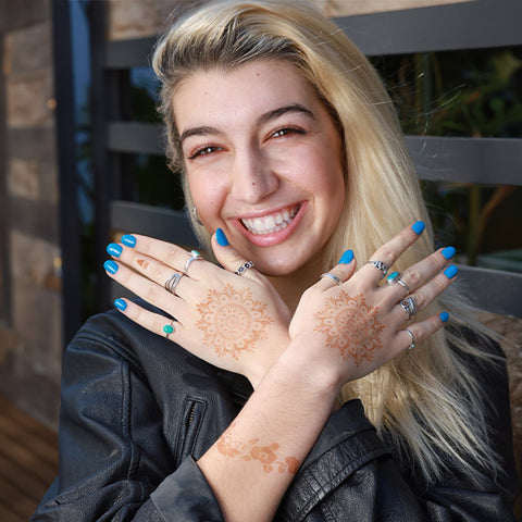 Two mandala henna designs on back of hands