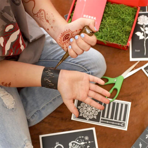 Girl Applying a Henna Tattoo with a Sticker Stencil