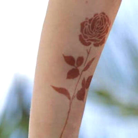 Rose henna flower tattoo on arm