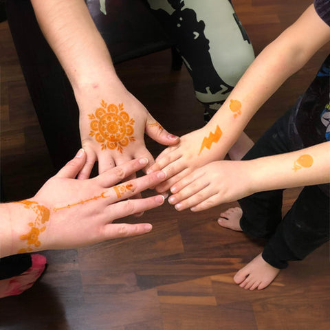 Various henna tattoo designs on backs of hands