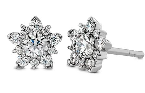 A stellar and radiant set of diamond stud earrings covered in diamonds.