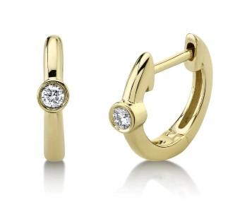 Yellow gold huggies earrings with a single diamond bezel set into each.