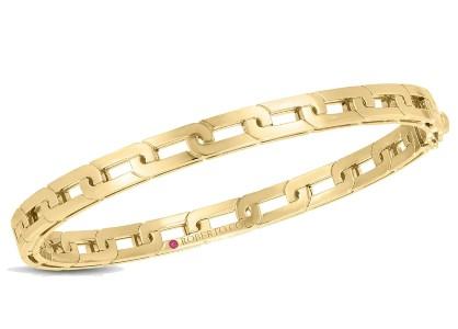 A yellow gold bangle with an elongated chain motif.