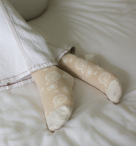 Besma from Curiously Conscious wearing beige Paisley ladies organic cotton socks