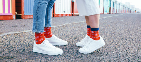 A man and woman wearing Men's & Women's Coronation Socks from Peper Harow