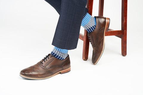 Man wearing smart brogues, navy trousers and blue Chord men's luxury socks from Peper Harow